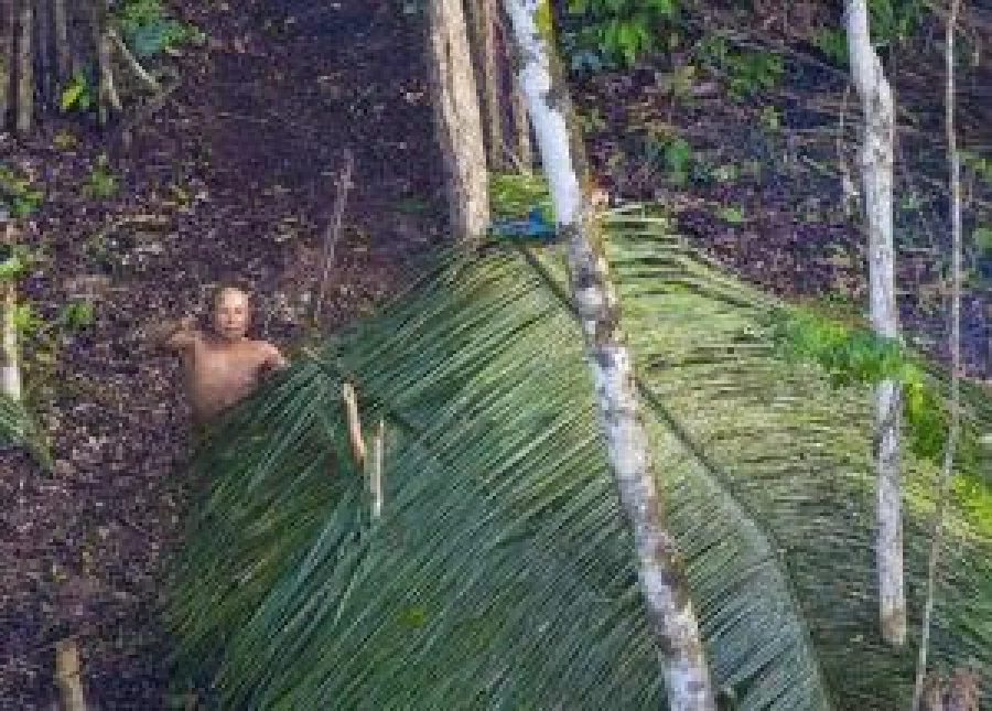 A villager points up at the helicopter. Ricardo Stuckert discovered the tribe after his flight was diverted.  THE GUARDIAN