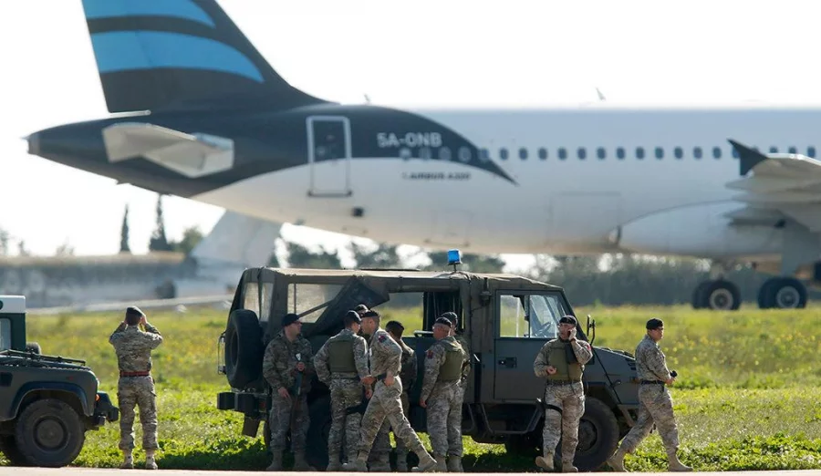 Maltese troops survey a hijacked Libyan Afriqiyah Airways Airbus A320 on the runway at Malta Airport, December 23, 2016 Reuters