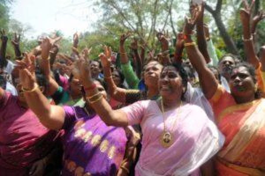 Supporters of the All India Anna Dravida Munnetra Kazhagham (AIADMK) party celebrate in front of the residence of the acting chief minister O Panneerselvam of the southern Indian state of Tamil Nadu in Chennai on February 14, 2017. India's Supreme Court jailed the annointed next leader of Tamil Nadu for four years for corruption on February 14, heightening the turmoil in a state still reeling from the death of its long-time matriarch. VK Sasikala was told to surrender immediately to prison authorities after judges overturned her acquittal in a long-running "disproportionate assets" case that also involved her late mentor Jayalalithaa Jayaram. Sasikala has been involved in a bitter battle in recent weeks with the state's acting chief minister O Panneerselvam who has been trying to block her ascent. / AFP PHOTO / ARUN SANKAR