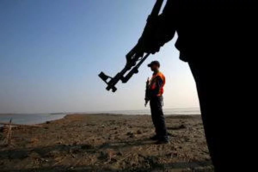 Bangladesh coast guards keep watch in the Thengar Char island in the Bay of Bengal, Bangladesh, February 2, 2017. Picture taken February 2, 2017. REUTERS/Mohammad Ponir Hossain TPX IMAGES OF THE DAY 
