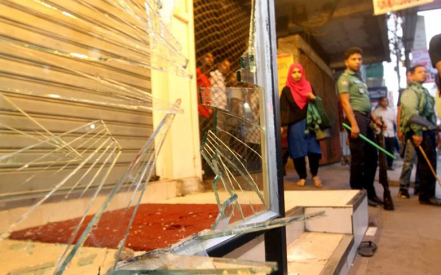 Police and onlookers at the scene after vandals had left Dhaka Tribune