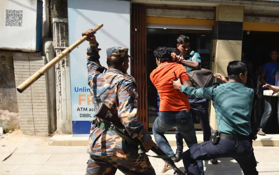 A law enforcer charging baton on a protester in Chittagong's anti-Rampal programme on February 25, 2017 Dhaka Tribune