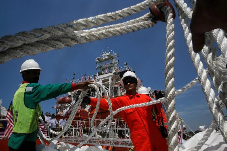Crew members load supplies on a Malaysian ship, carrying aid for Rohingya, to set sail for Myanmar in Port Klang, Malaysia on February 3, 2017 Reuters