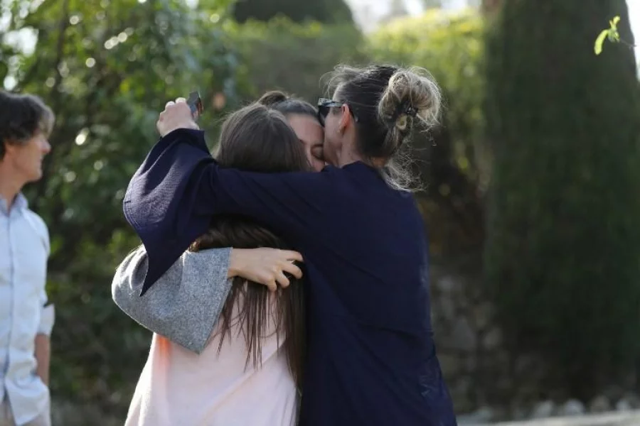 People react near the Tocqueville high school in the southern French town of Grasse, on March 16, 2017 following a shooting that left two people injured. At least two people were injured in a shooting at a high school in the southern French town of Grasse on March 16, 2017 which saw the head teacher targeted, police and local authorities said. One 17-year-old pupil armed with a rifle, two handguns and two grenades was arrested after the shooting at the Tocqueville high school, a police source told AFP, asking not to be named.  / AFP PHOTO / Valery HACHE