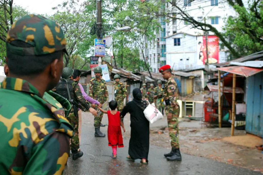 Army officers escort one of the rescued families from the Sylhet militant hideout Dhaka Tribune