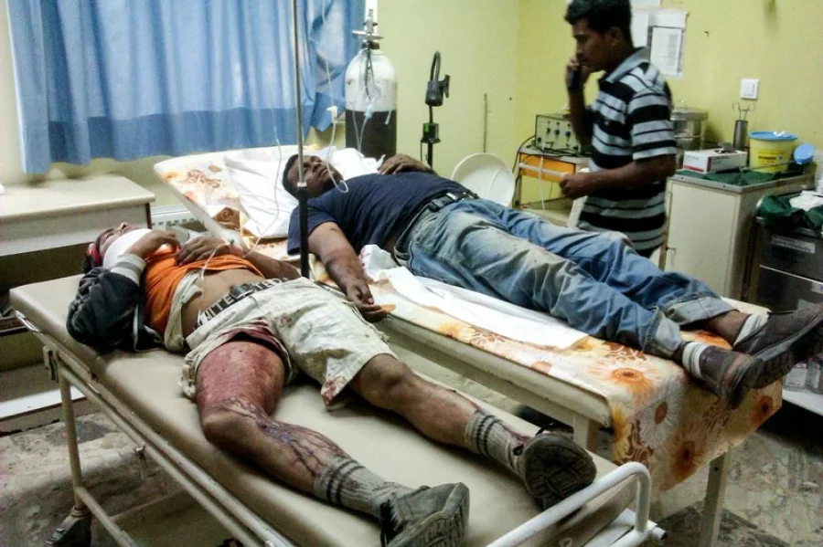 FILE - In this Wednesday, April 17, 2013, file photo unidentified migrant workers receive first aid at the Medical Center of Varda, in southwestern Greece. A group of strawberry pickers from Bangladesh have won a case on Thursday, March 30, 2017 against Greece at Europe's highest human rights court, after being shot at by employers for demanding unpaid wages. (Eurokinissi via AP)