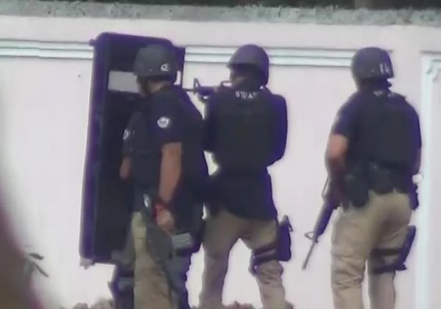 Members of SWAT approach the Borohat den with a riot shield for protection Saiful Islam/Dhaka Tribune