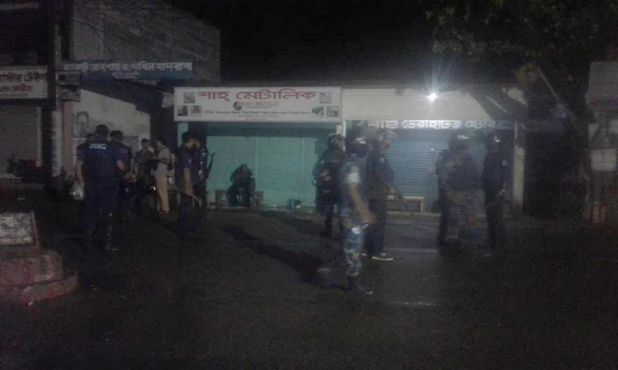 Law enforcement officials standing outside a madrasa located near the Borohat militant den Saiful Islam/Dhaka Tribune