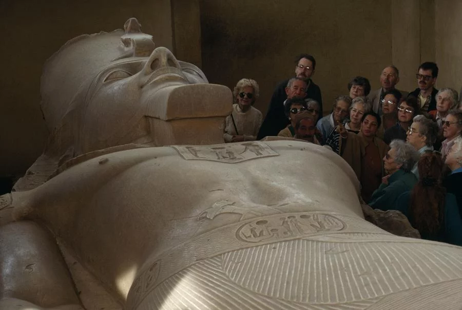 Museum tourists admire an enormous carving of Pharaoh Ramses II. NATIONAL GEOGRAPHIC