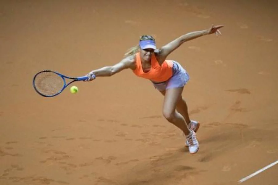 Russia's Maria Sharapova returns to France's Kristina Mladenovic during their semi-final tennis match at the WTA Porsche Tennis Grand Prix in Stuttgart, southwestern Germany, on April 29, 2017. / AFP PHOTO / THOMAS KIENZLE