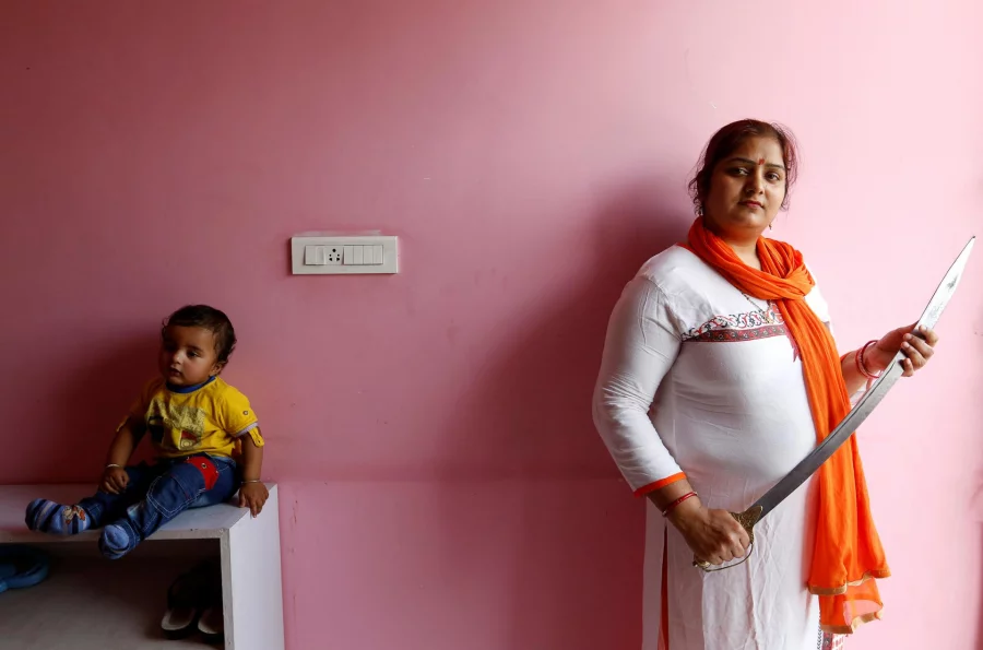 Hindu Yuva Vahini member Kusum Singh, 30, poses inside the vigilante group's office in the city of Unnao, India, April 5, 2017. Picture taken April 5, 2017. REUTERS/Cathal McNaughton    To Match Insight INDIA-POLITICS/RELIGION
