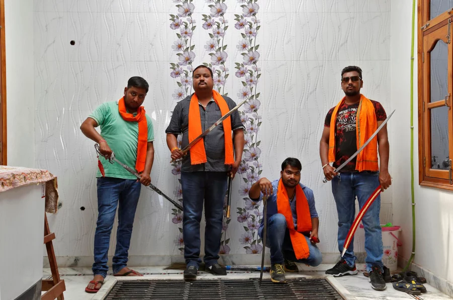 Hindu Yuva Vahini members pose inside the vigilante group's office in the city of Unnao, India, April 5, 2017. Picture taken April 5, 2017. REUTERS/Cathal McNaughton    To Match Insight INDIA-POLITICS/RELIGION