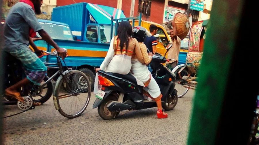 Two women dressed in Boishakhwear on a scooter in Karwan Bazar in Dhaka on April 13, 2017 Courtesy: Sushobhan Sarker