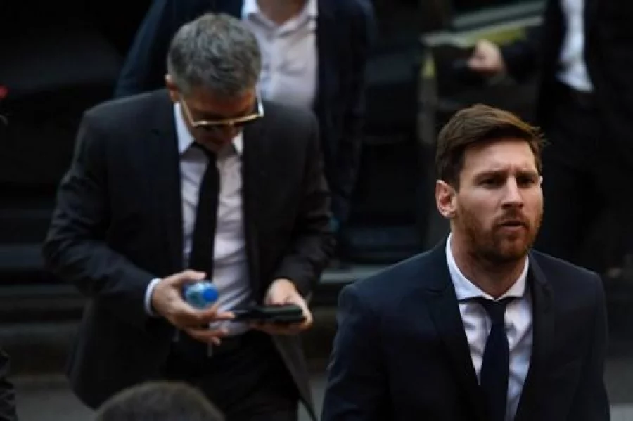 (FILES) This file photo taken on June 2, 2016 shows Barcelona's football star Lionel Messi (R) followed by his father Jorge Horacio Messi arriving at the courthouse on June 2, 2016 in Barcelona, where Messi and his father are to face judges in a tax fraud case. Spain's Supreme Court on May 24, 2017 confirmed a 21-month jail sentence and 2.09-million-euro ($2.25 million) fine imposed on Lionel Messi for tax fraud, months after the Barcelona football star lodged an appeal.  / AFP PHOTO / Josep LAGO