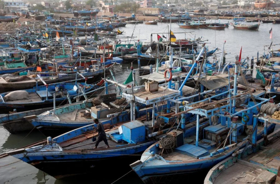 A fisherman cleans a portion of a boat anchored at Ibrahim Hyderi, on the outskirts of Karachi, Pakistan on June 1, 2017 Reuters