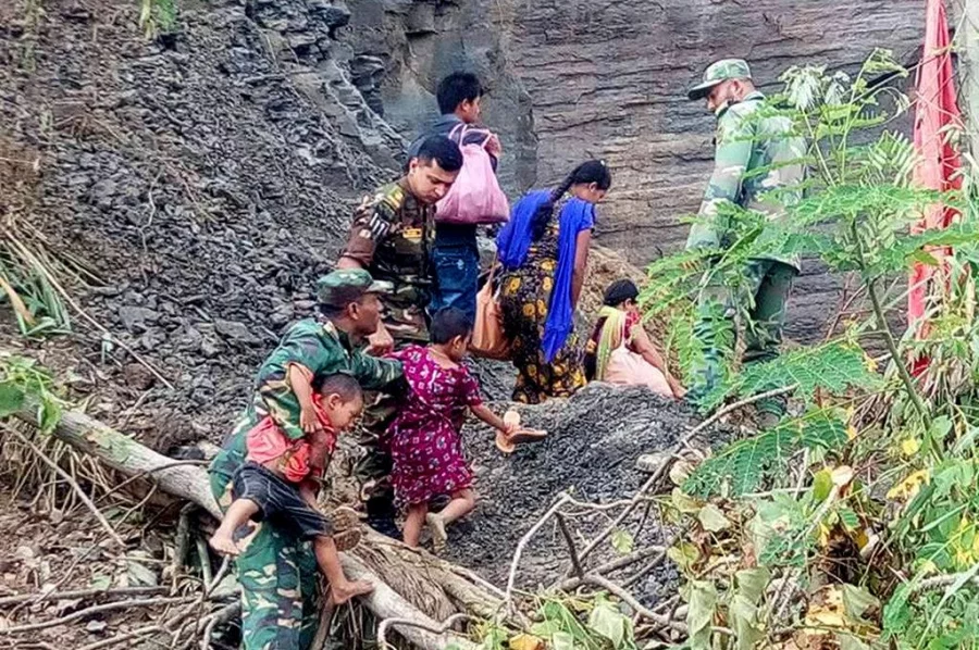 Due to downed communication lines in Rangamati, members of Bangladeshi Army are helping residents to make their way through Dhaka Tribune