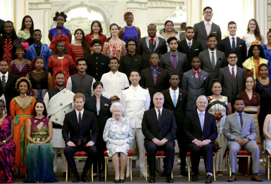 Queen Elizabeth II poses in a group photo with Prince Harry and Bangladesh's Rahat Hossain and Sajid Iqbal at the Queen's Young Leaders Awards ceremony at Buckingham Palace in London AFP