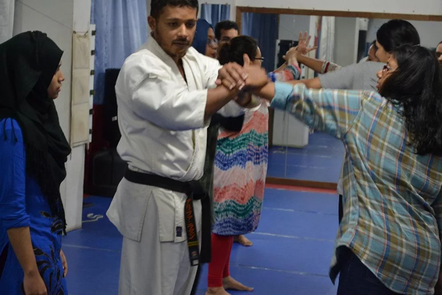 A trainer shows how to block a punch and use the attacker's motion against them Courtesy