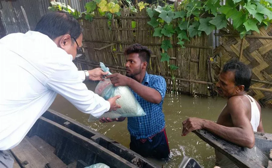 The deputy commissioner of Moulvibazar distributes relief among villagers affected by the flood on July 3, 2017 Dhaka Tribune