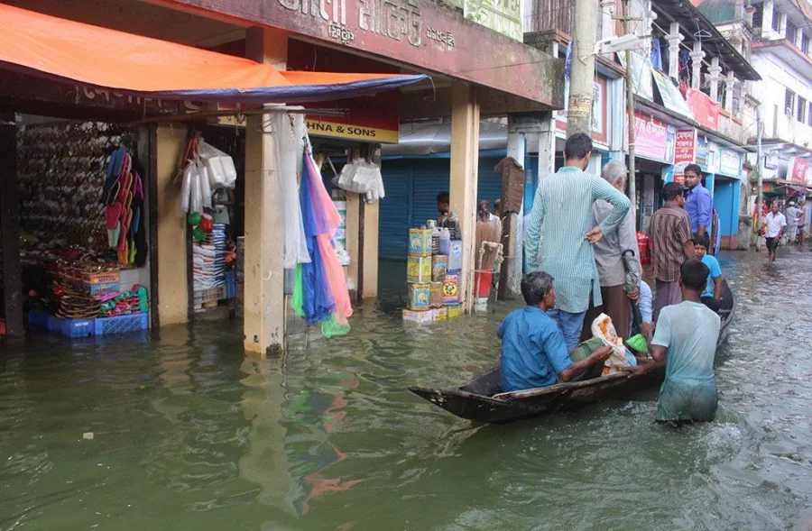 Locals carry out their daily shopping on boats at a market in Fenchuganj in spite of the flood on July 2, 2017 Dhaka Tribune