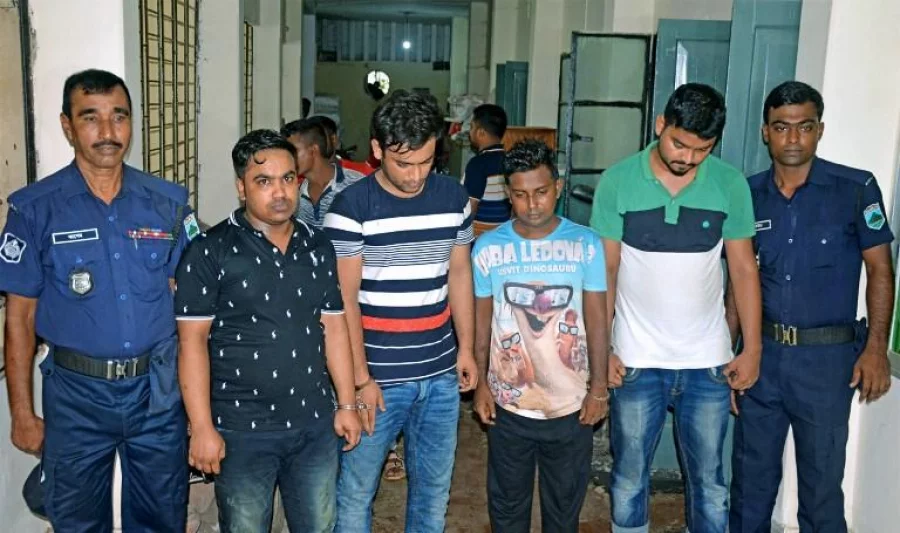 Tufan Sarker (2L) a labour leader linked with the ruling Awami League party, along with three of his associates, is escorted by police following their arrest in Bogra on July 29, 2017. Bangladesh police have arrested four men over the rape of a teenager whose head was shaved as punishment by the accused's wife in a case that has shocked the conservative country, an official said July 30. / AFP PHOTO / STR