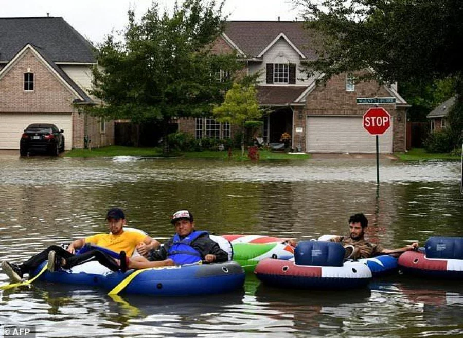 Rescue volunteers after clearing out all the evacuees from the Twin Oaks Estate in the Clodine district after Hurricane Harvey caused heavy flooding in Houston, Texas |AFP