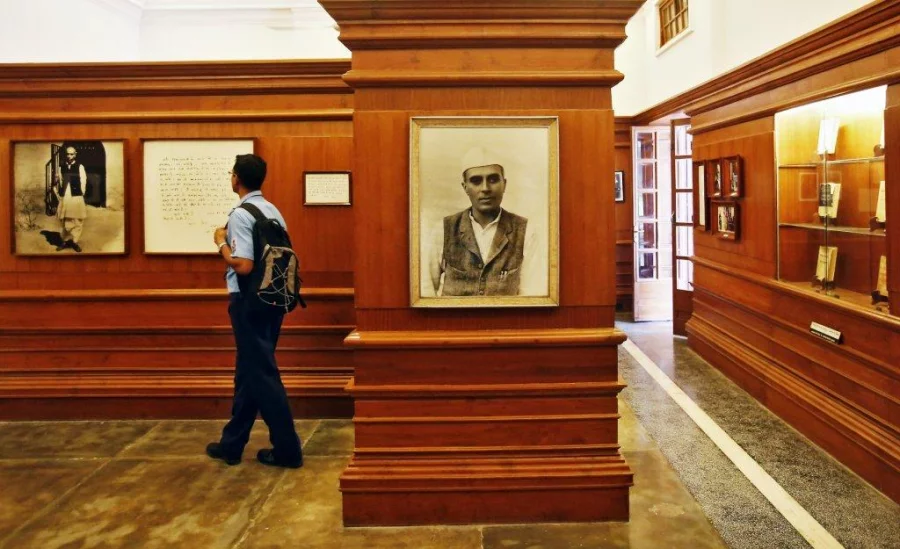 FILE PHOTO: A visitor stands next to a portrait of India's first Prime Minister Jawaharlal Nehru inside the Nehru memorial museum and library in New Delhi, India, September 24, 2015. To match Special Report INDIA-MODI/CULTURE REUTERS/Anindito Mukherjee/File Photo